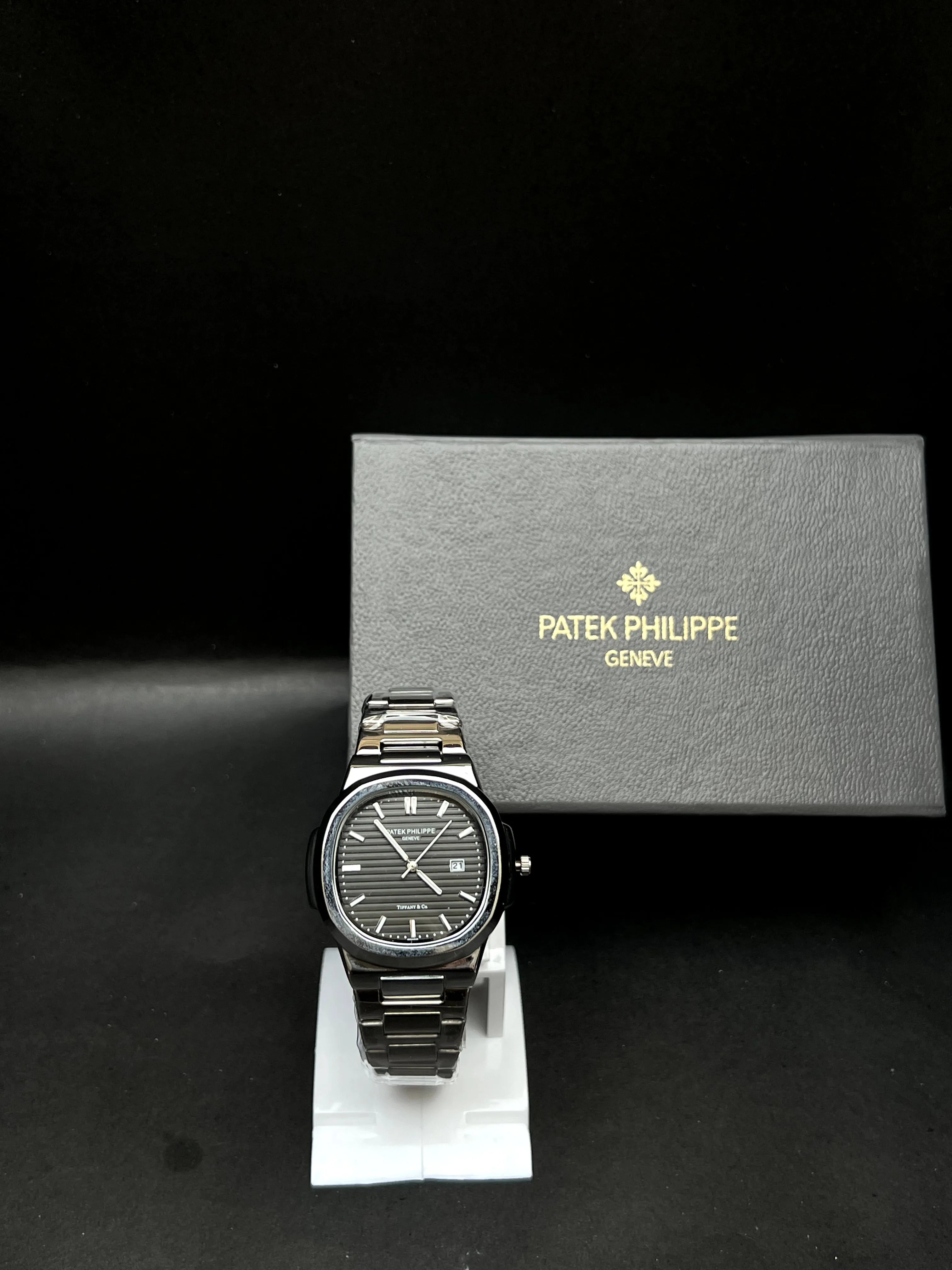 Patek Philippe Nautilus, a rich black horizontally embossed dial, date window at 3 o’clock is seamlessly integrated