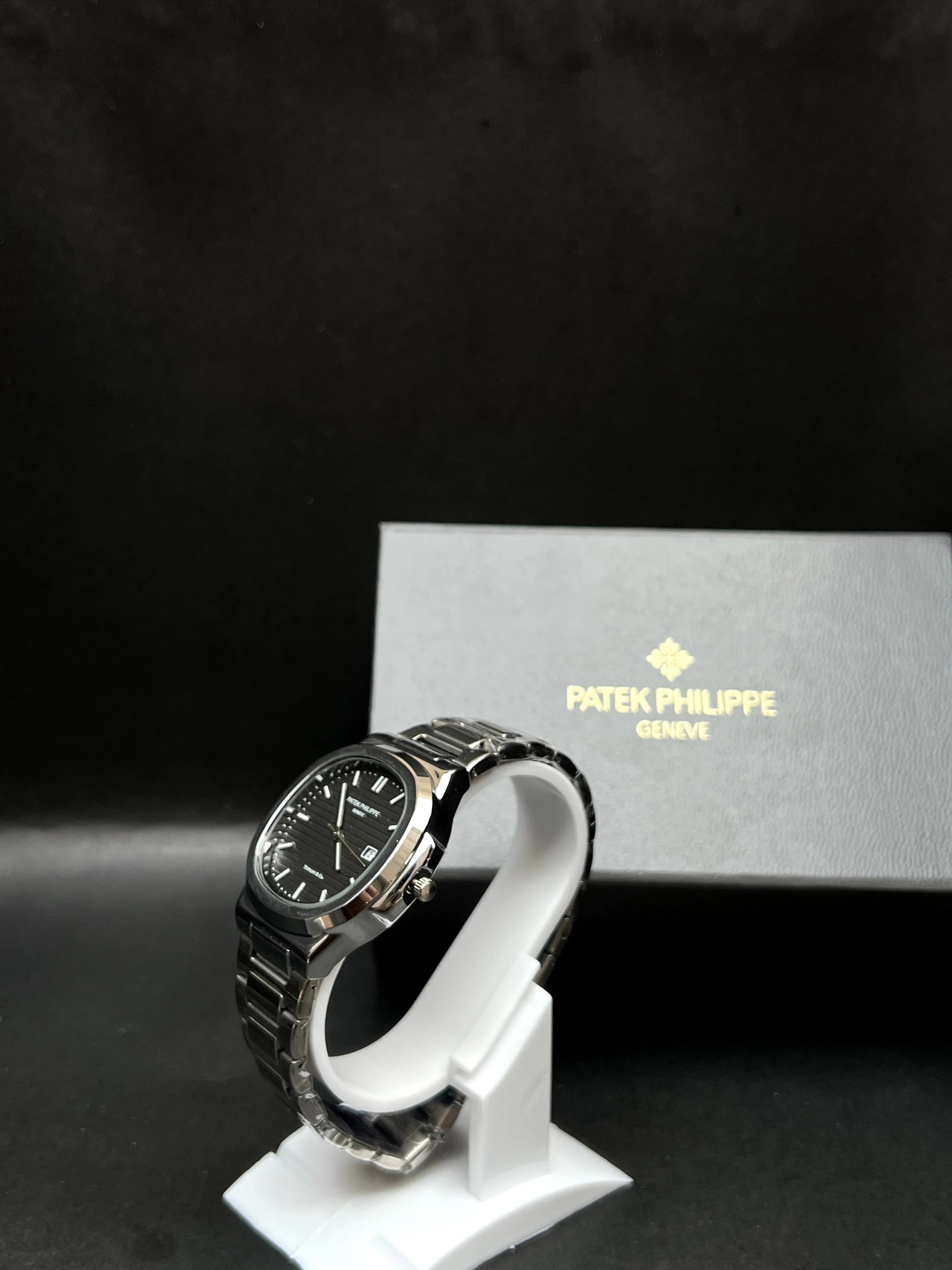 Patek Philippe Nautilus, a rich black horizontally embossed dial, date window at 3 o’clock is seamlessly integrated