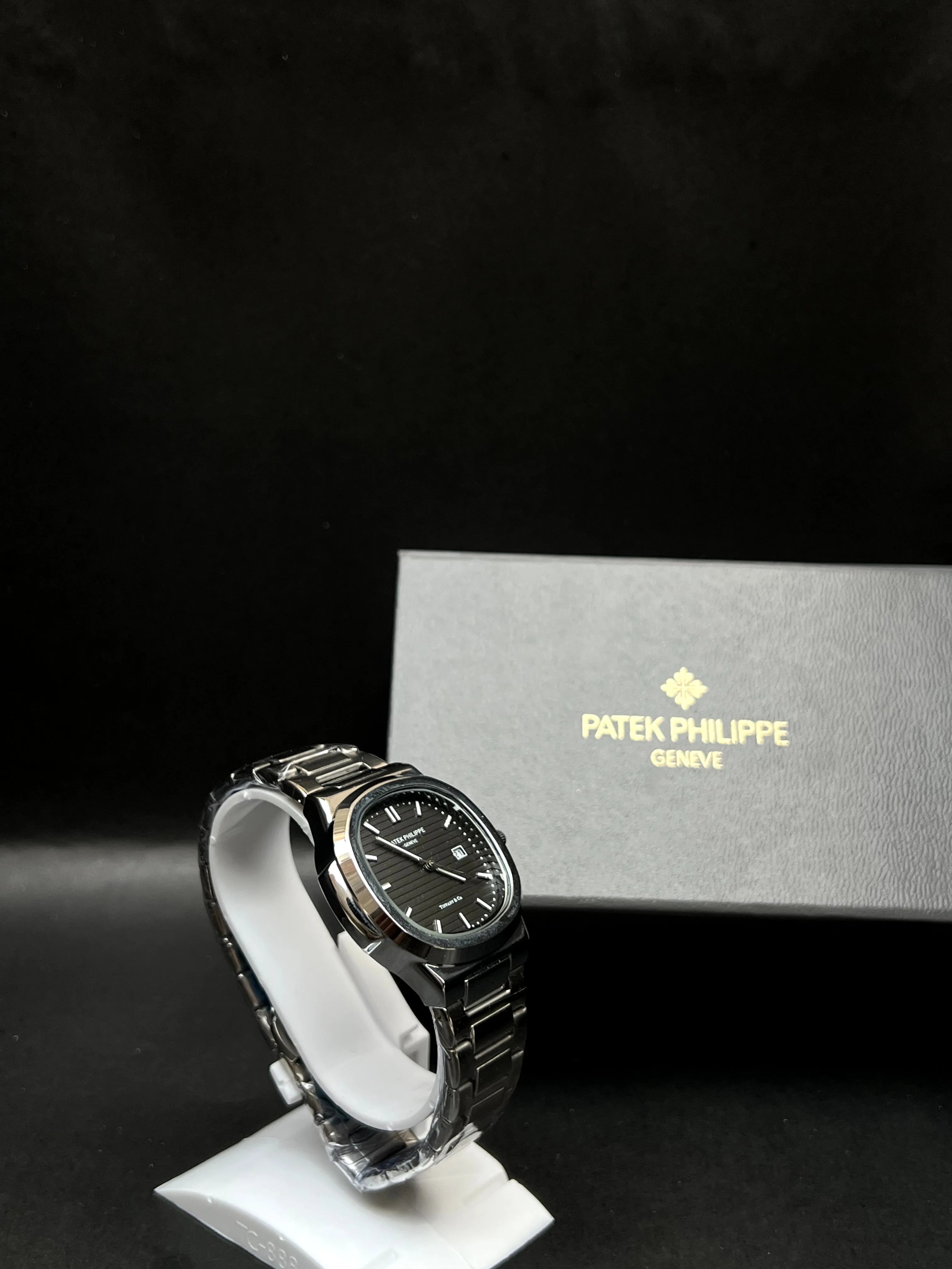 Patek Philippe Nautilus, a rich black horizontally embossed dial, date window at 3 o’clock is seamlessly integrated