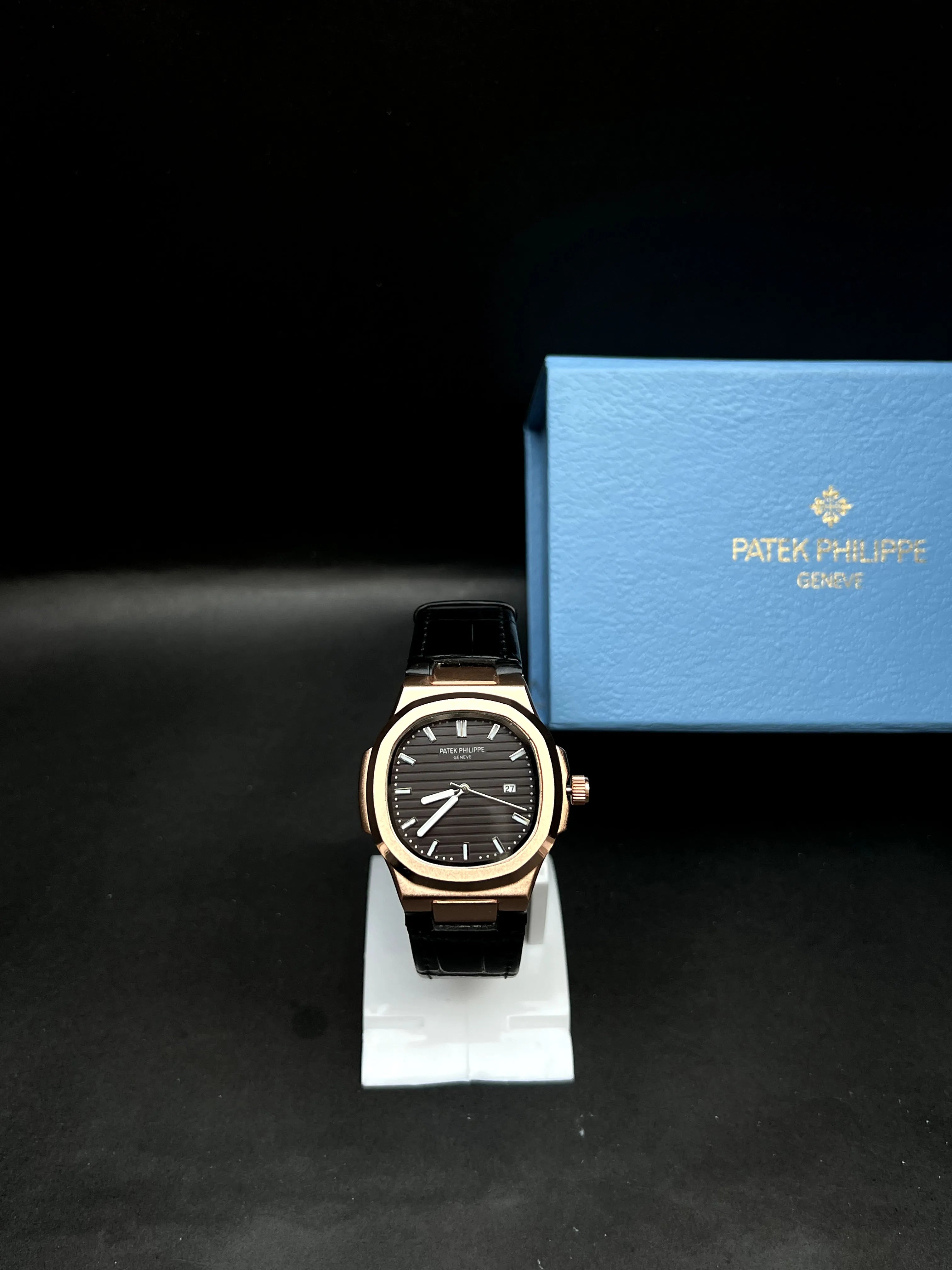 Patek Philippe Nautilus, Black with horizontal embossing, luminous hands, and date at 3 o’clock.