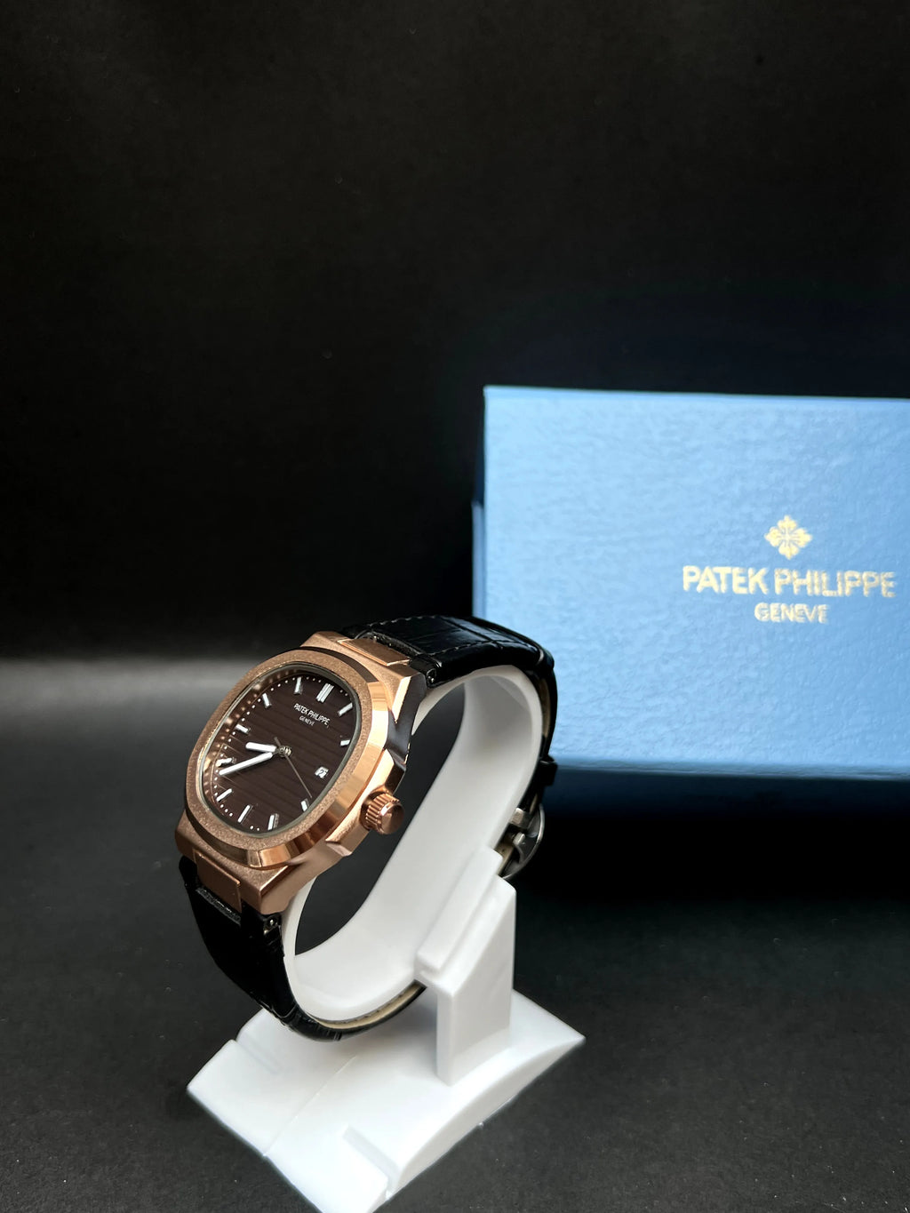 Patek Philippe Nautilus, Black with horizontal embossing, luminous hands, and date at 3 o’clock.