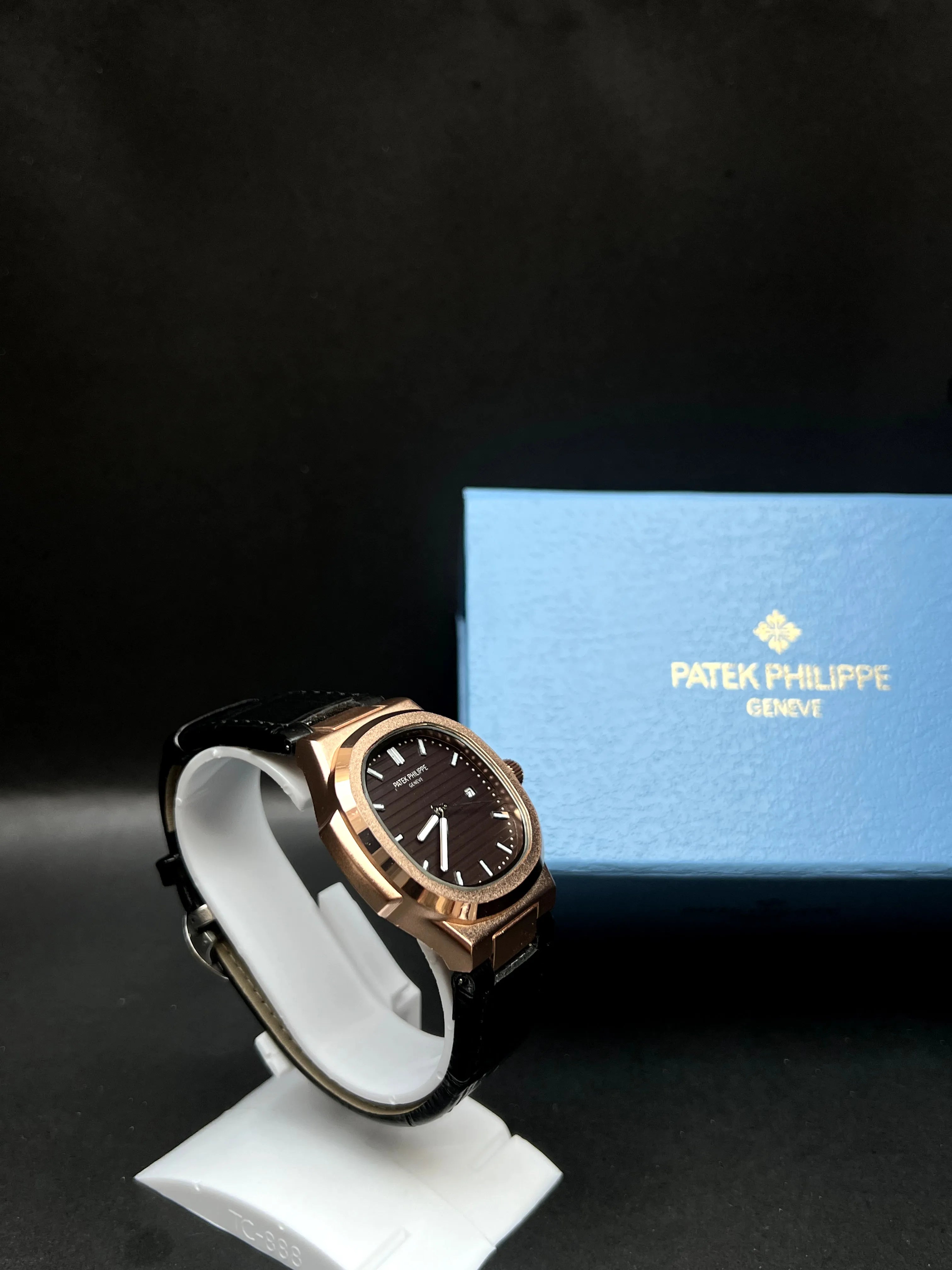Patek Philippe Nautilus, Black with horizontal embossing, luminous hands, and date at 3 o’clock.