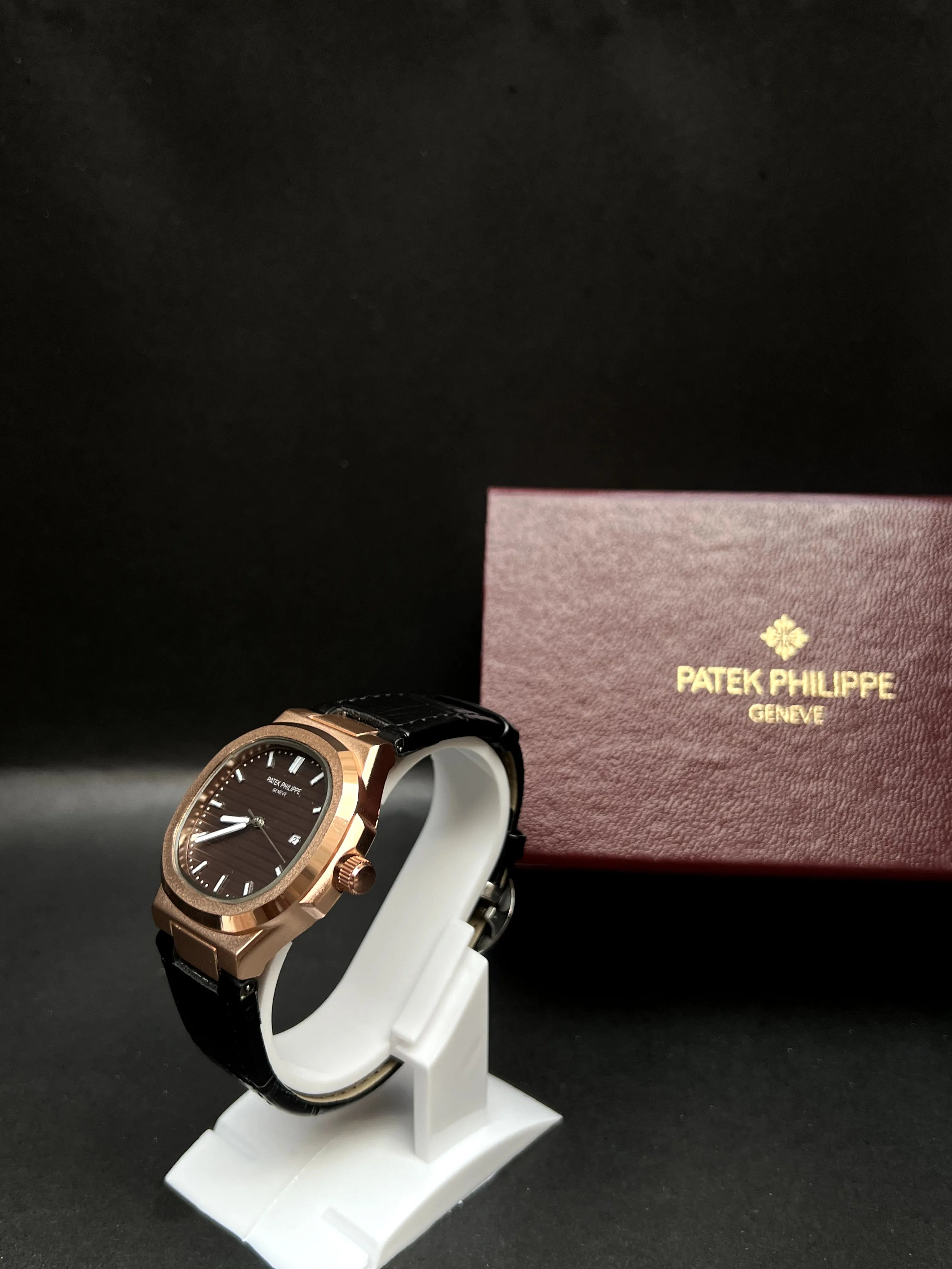 Patek Philippe Nautilus, Black with horizontal embossing, luminous hands, and date at 3 o’clock.