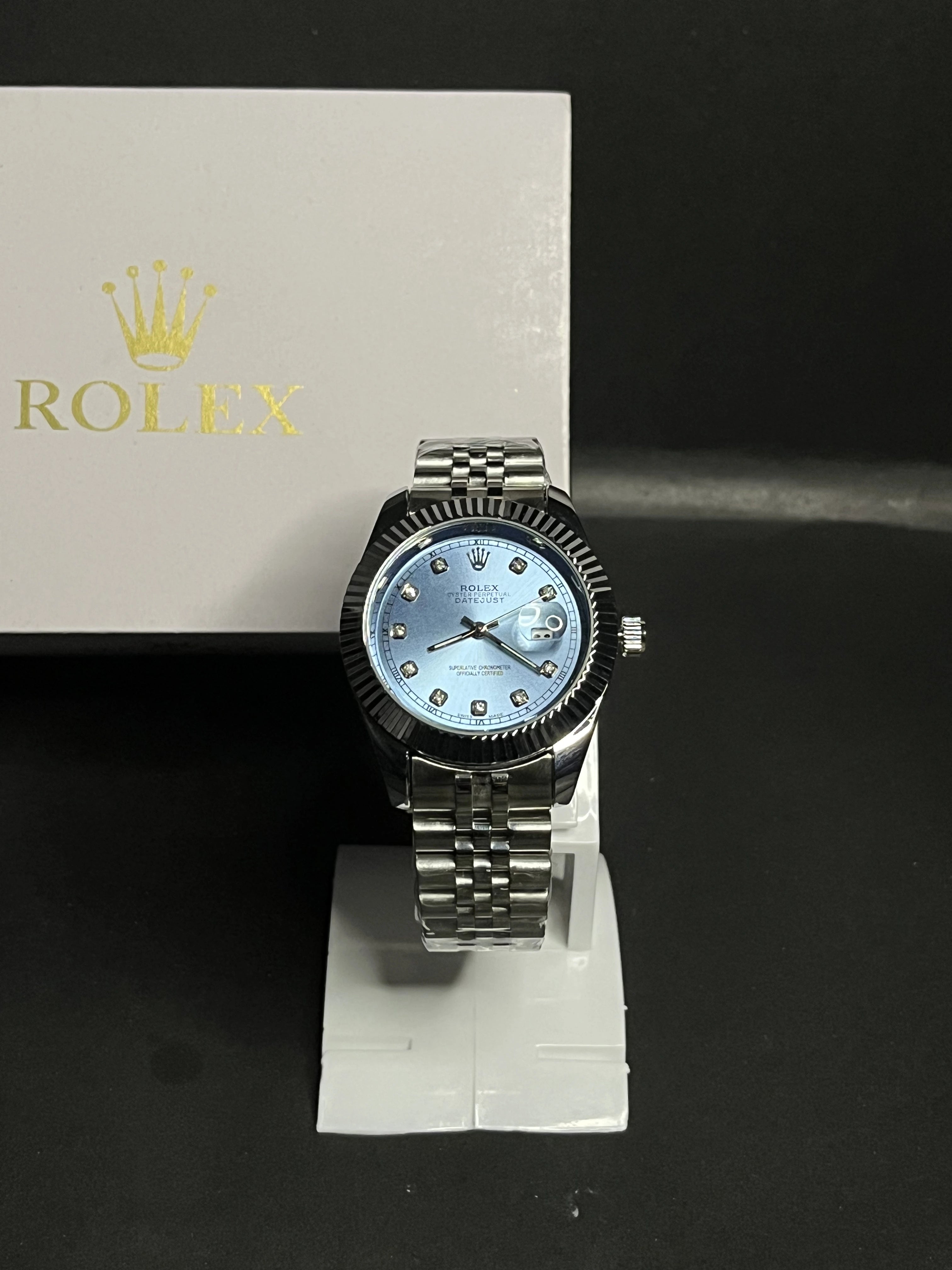 Rolex Oyster Perpetual Datejust featuring an elegant ice-blue dial adorned with diamond hour markers.