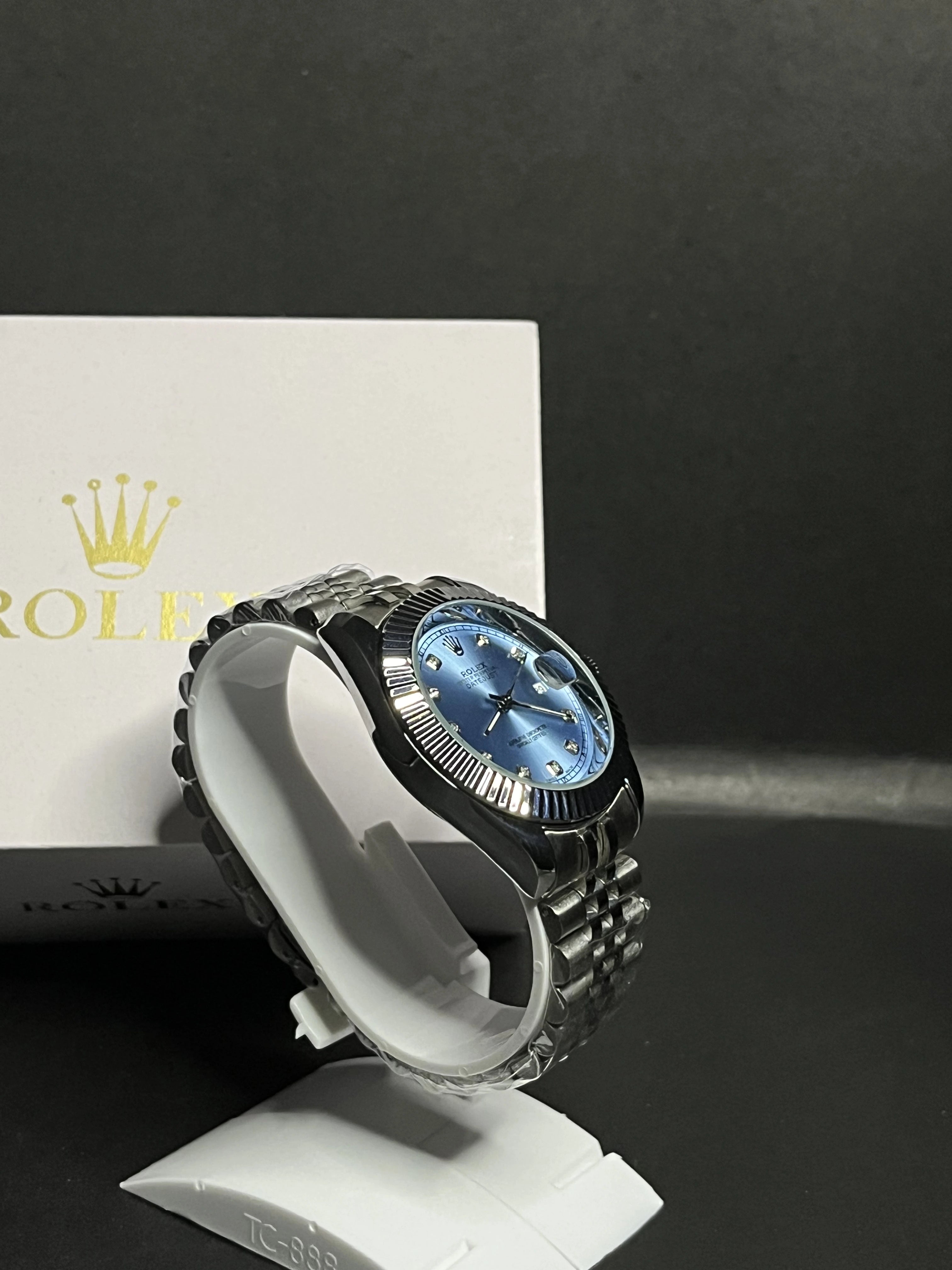 Rolex Oyster Perpetual Datejust featuring an elegant ice-blue dial adorned with diamond hour markers.