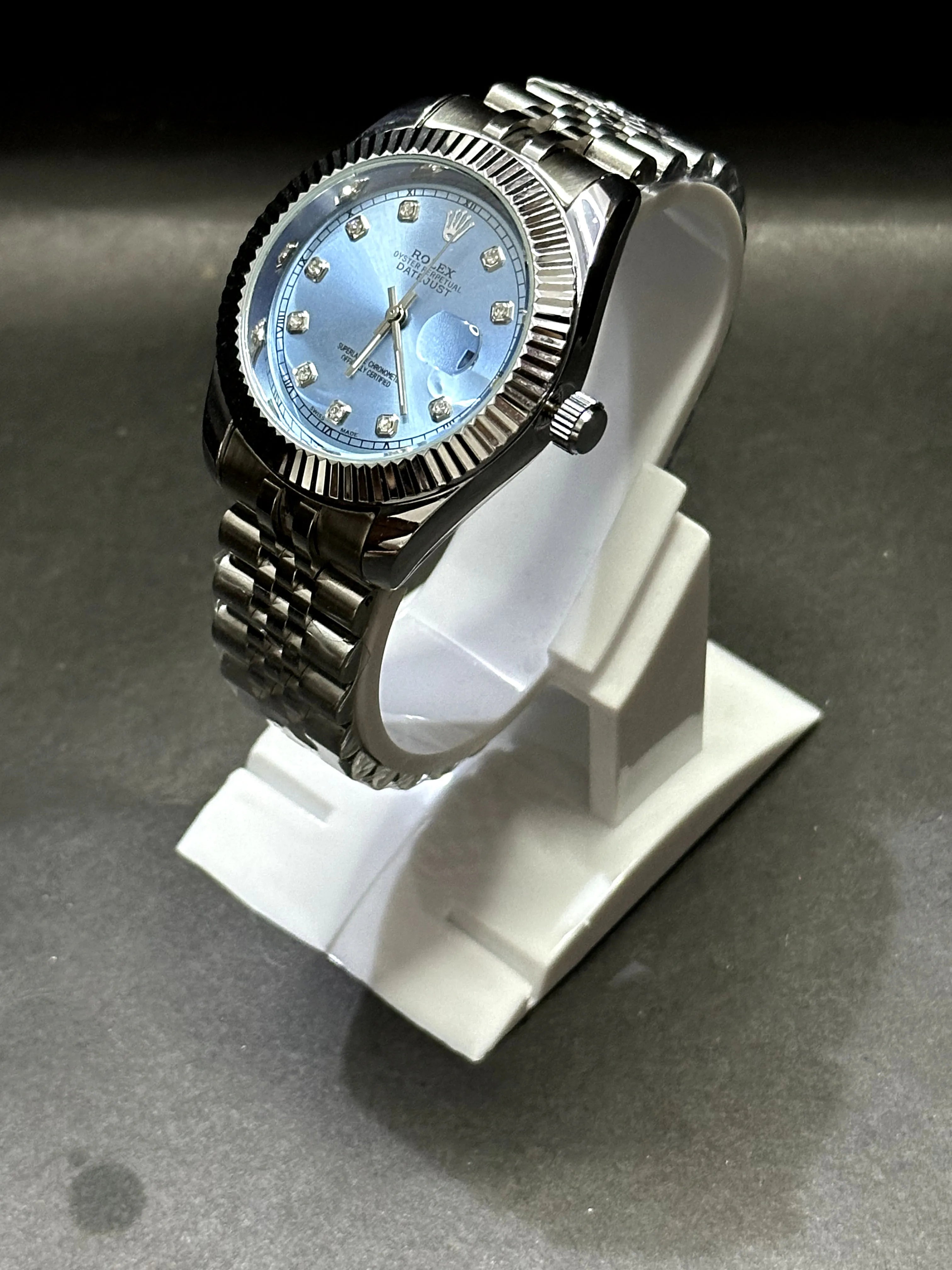 Rolex Oyster Perpetual Datejust featuring an elegant ice-blue dial adorned with diamond hour markers.